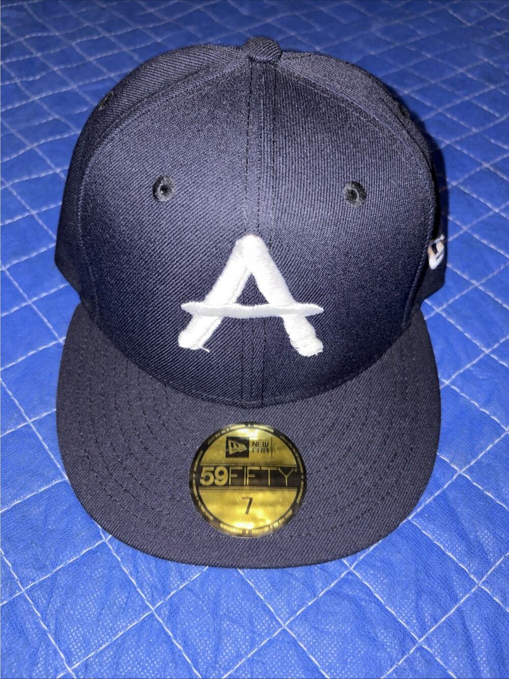 New Era Navy Blue and White 59FIFTY Fitted Hat with 'A' Patch it is a 7